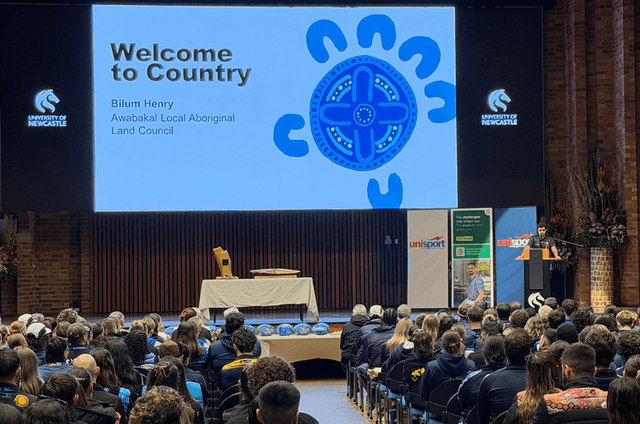 Bilum Henry from the Awabakal Local Aboriginal Land Council delivers the Welcome to Country at the opening ceremony of the 2026 Indigenous Nationals at the University of Newcastle.